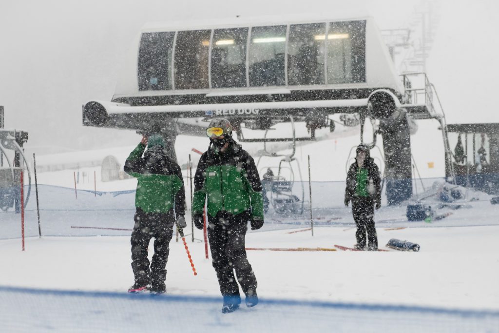 Lift operators wearing masks on a stormy day at Squaw Valley