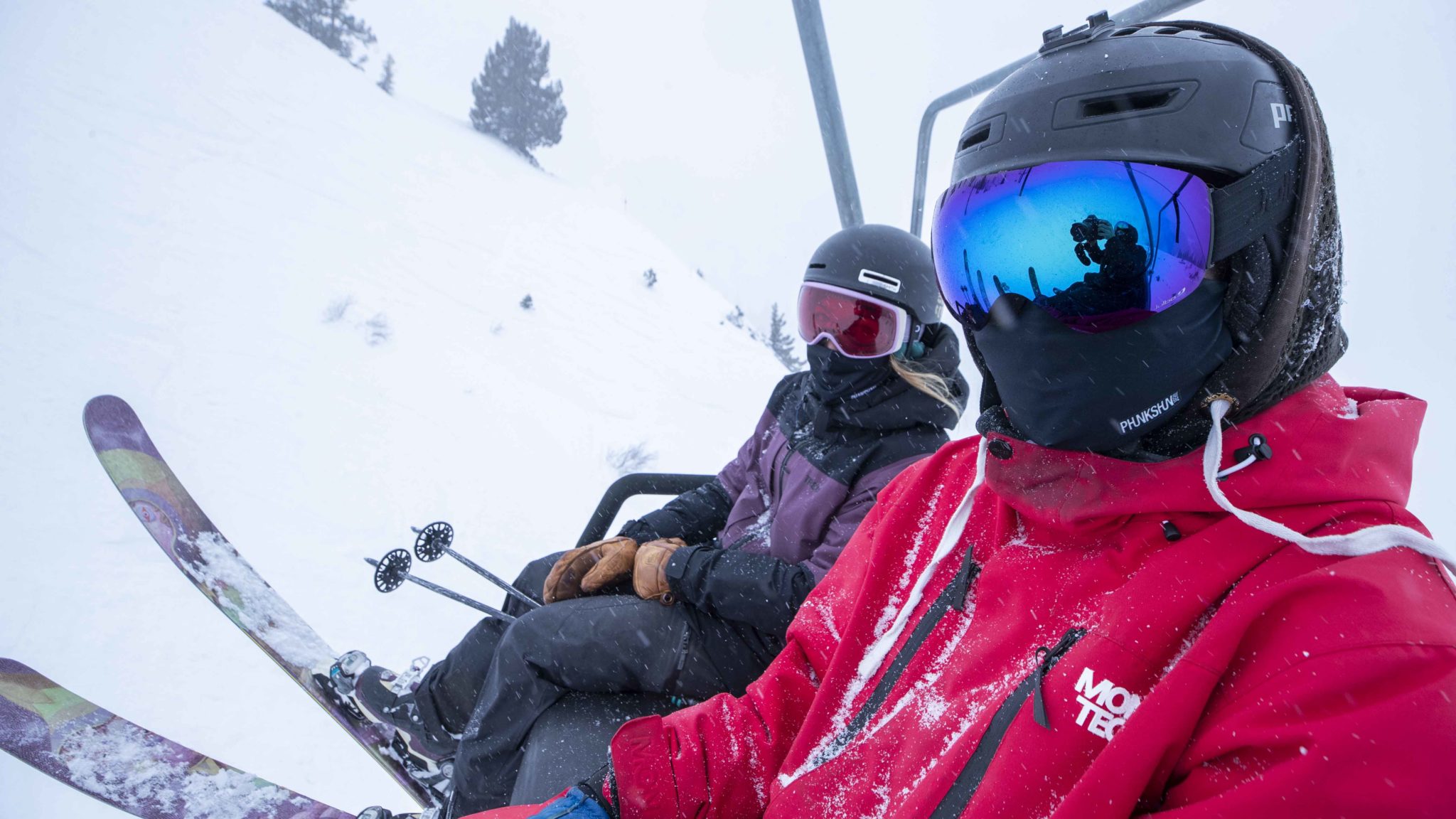 Two skiers wear their Phunkshun facemasks on a lift at Squaw Alpine.