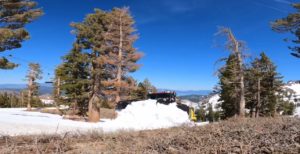 Snow cat pushing snow for late spring skiing at Palisades Tahoe
