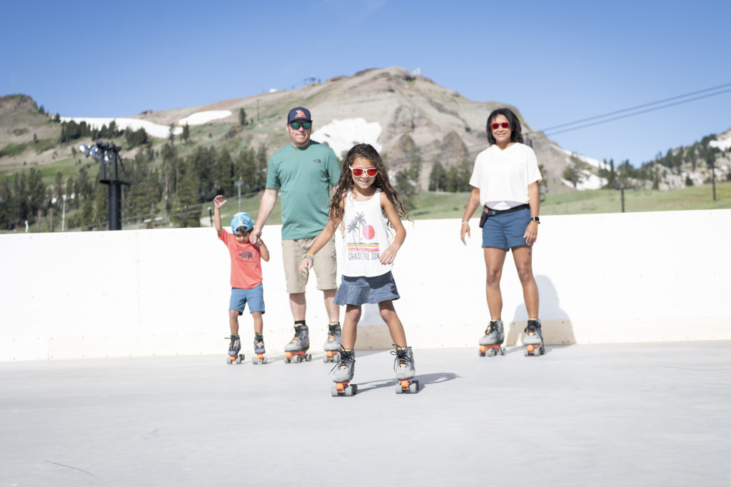 Family roller skating mountaintop at High Camp