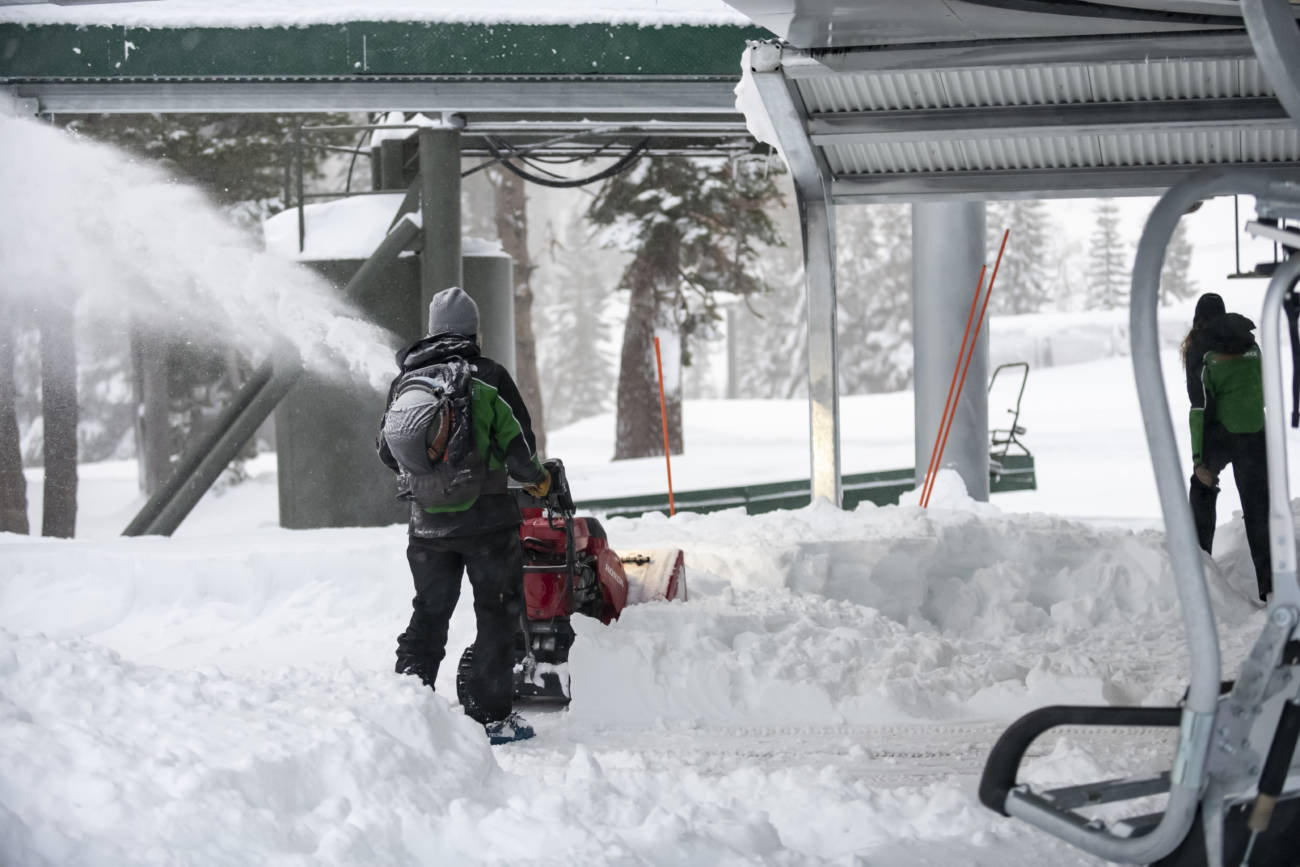 Palisades Tahoe employee blowing snow at Alpine