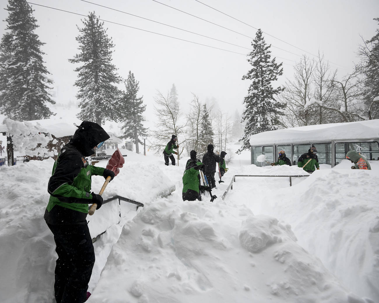 Palisades Tahoe employees digging out during a blizzard