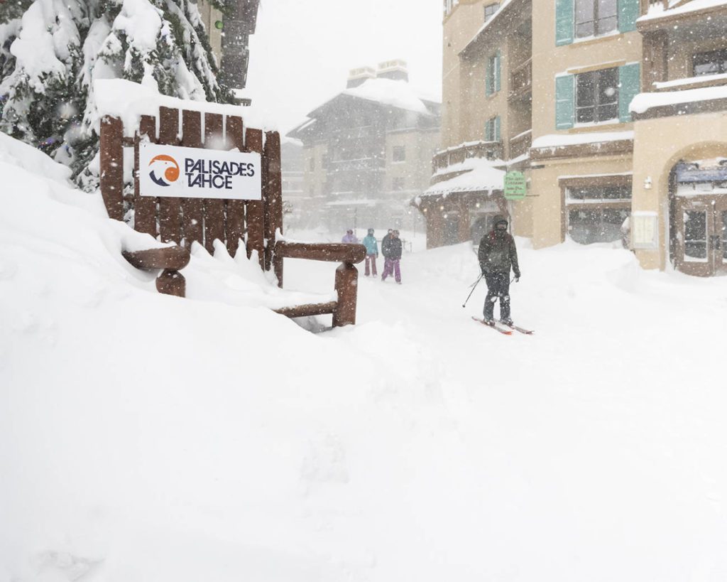 Skier going through the Village at Palisades during a blizzard