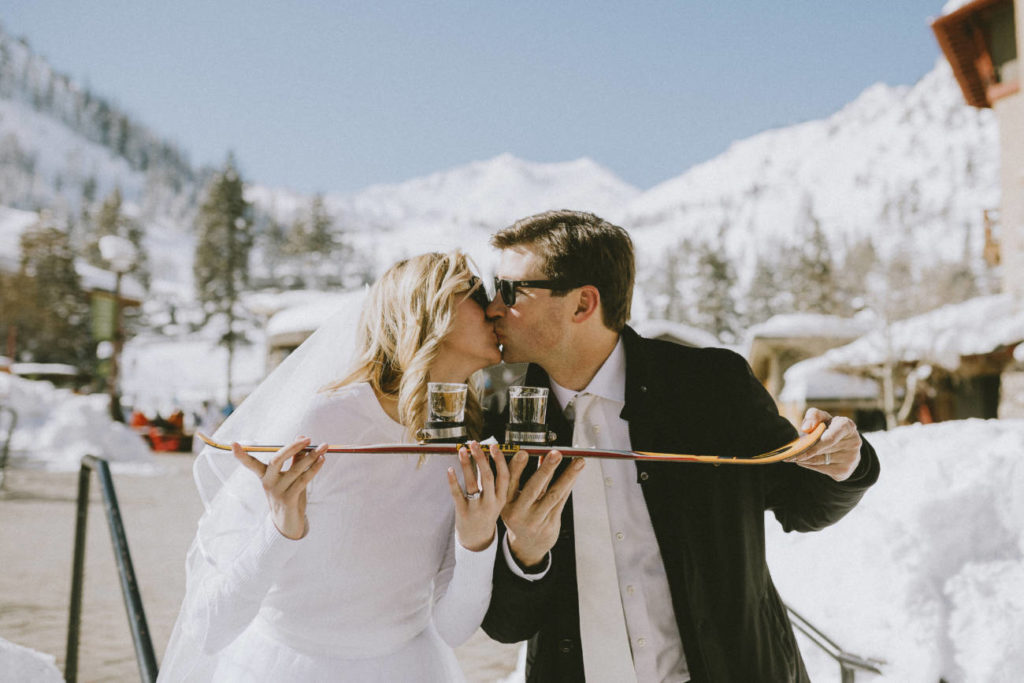 Bride and Groom taking a shotski in The Village at Palisades Tahoe