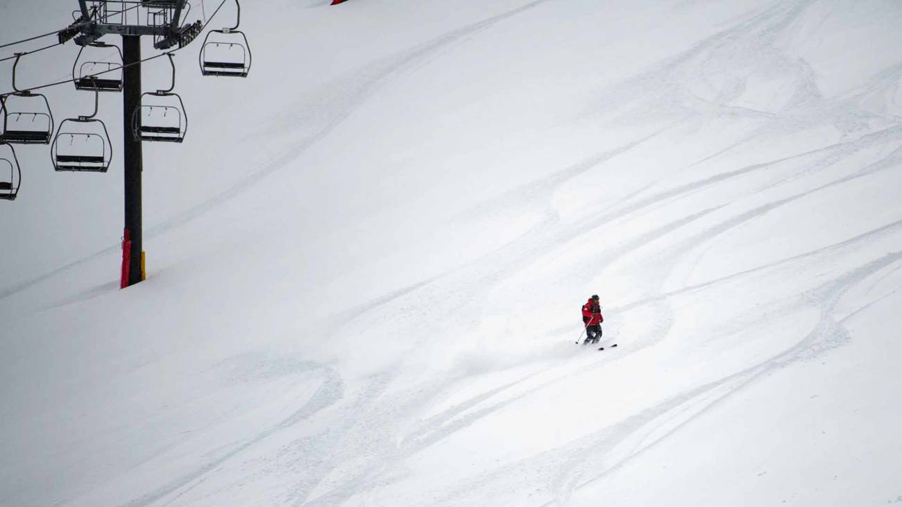 A ski patroller rides through fresh snow at Palisades Tahoe.