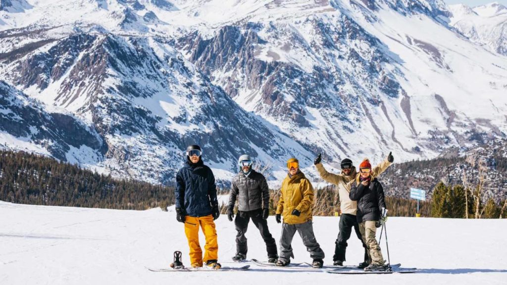 A group of snowboarders in the June Mountain base area. 