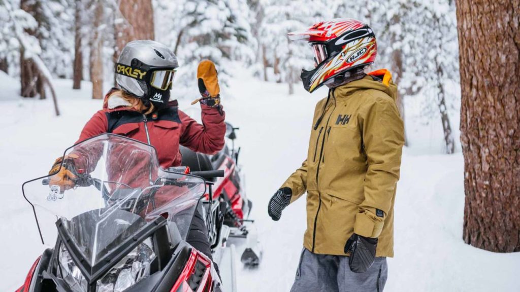A couple enjoys a snowmobile outing at Mammoth Mountain.