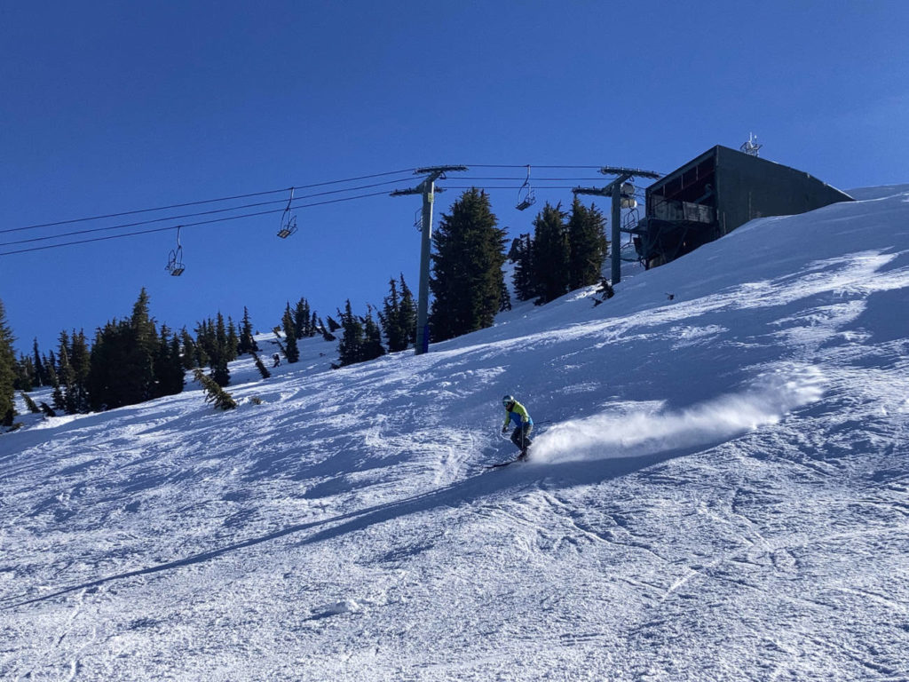 Skier cruising down Alpine Bowl trail