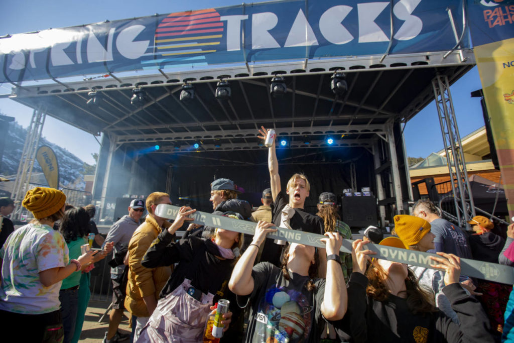 A crowd of people taking a shotski at the Spring Tracks concert