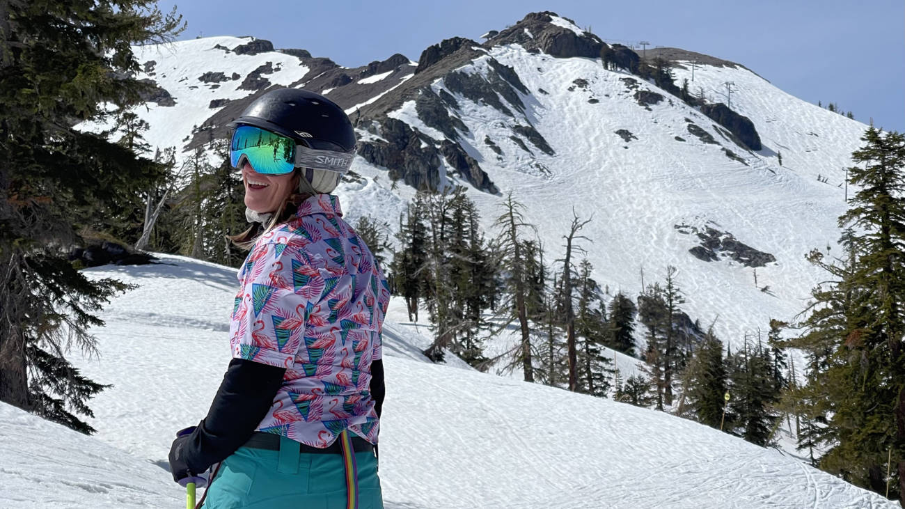 Woman smiling at the top of the Slot at Palisades Tahoe in Spring