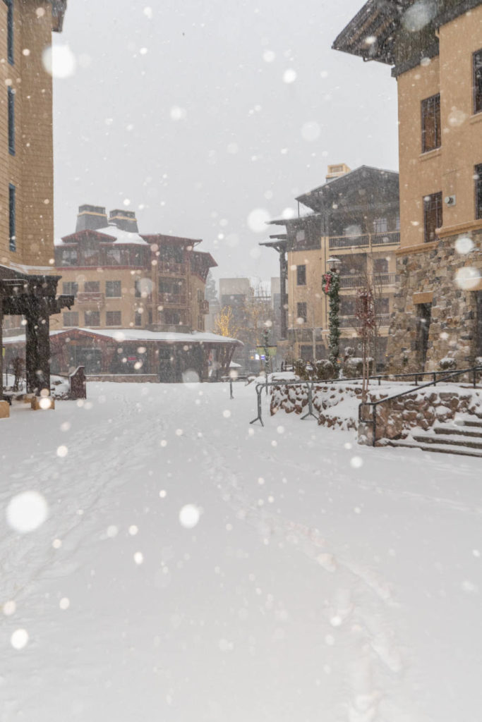 Snow falls in The Village at Palisades Tahoe in December 2022.