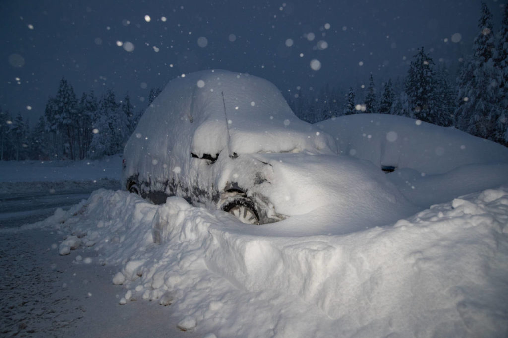 A Snow-Covered Car in the Village parking lot.