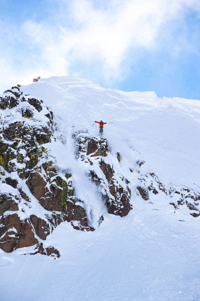 A skier with Teton Gravity Research hucks off the palisades.
