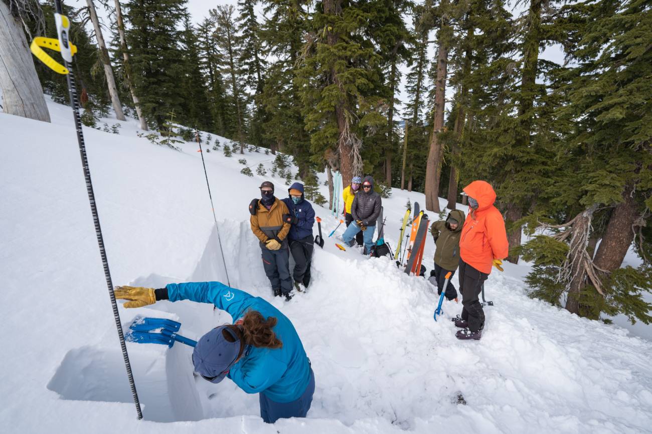 Alpenglow Expeditions class watching snow pack demonstration.