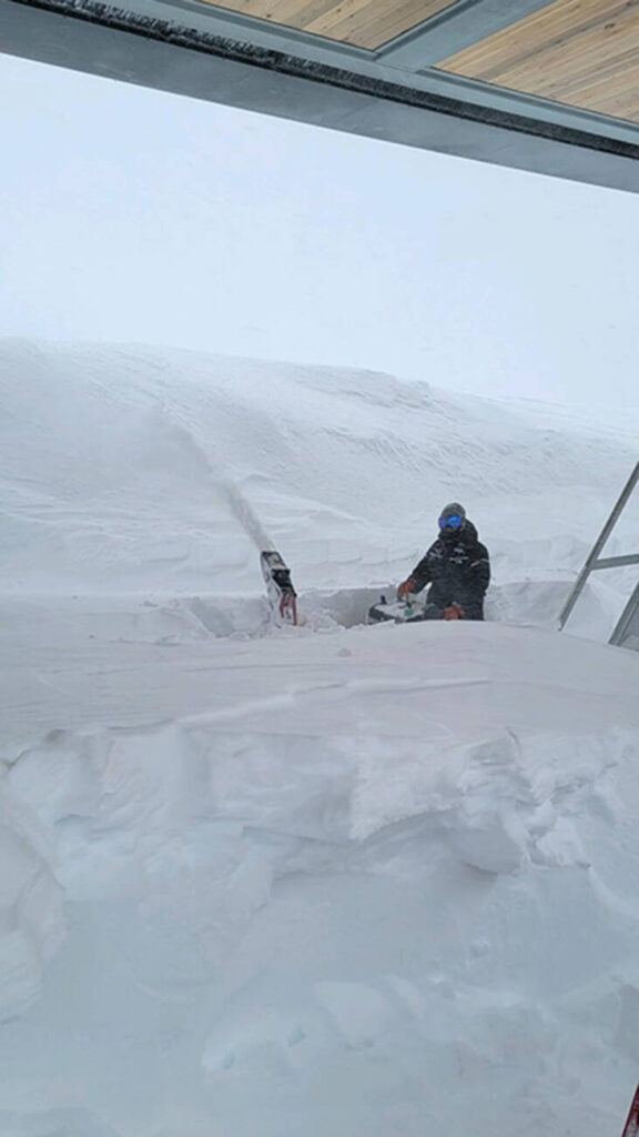 Angie Hong, Lift Maintenance, using a snowblower to clear the KT midstation of the Base to Base Gondola.