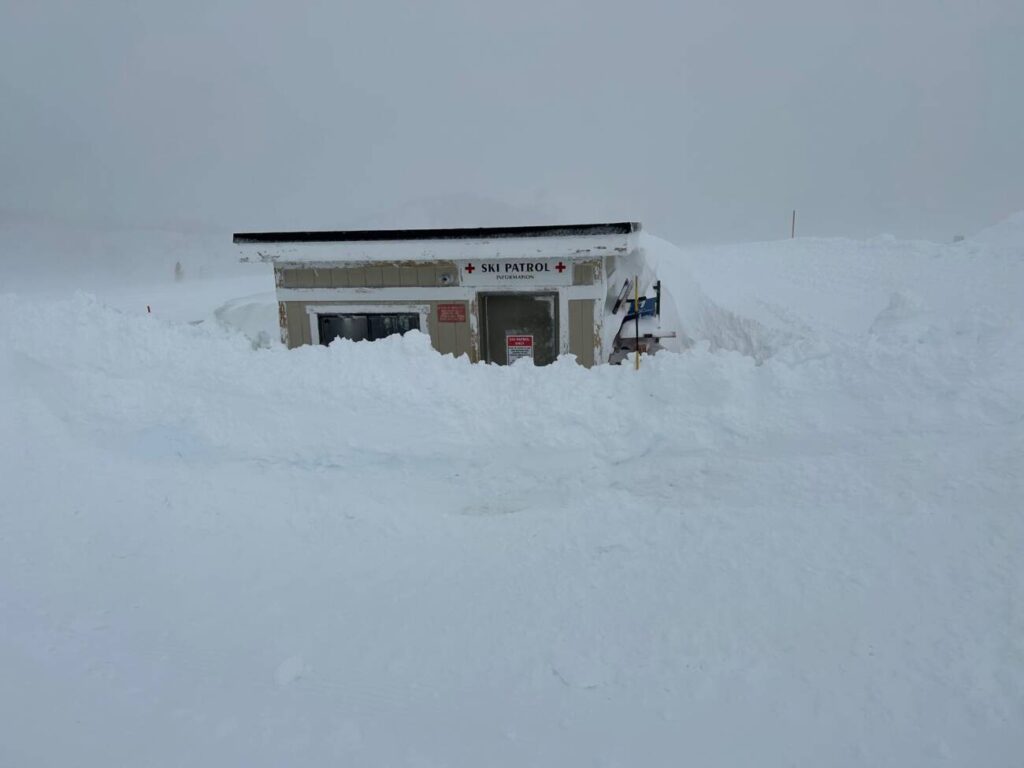 A patrol shack buried in snow.