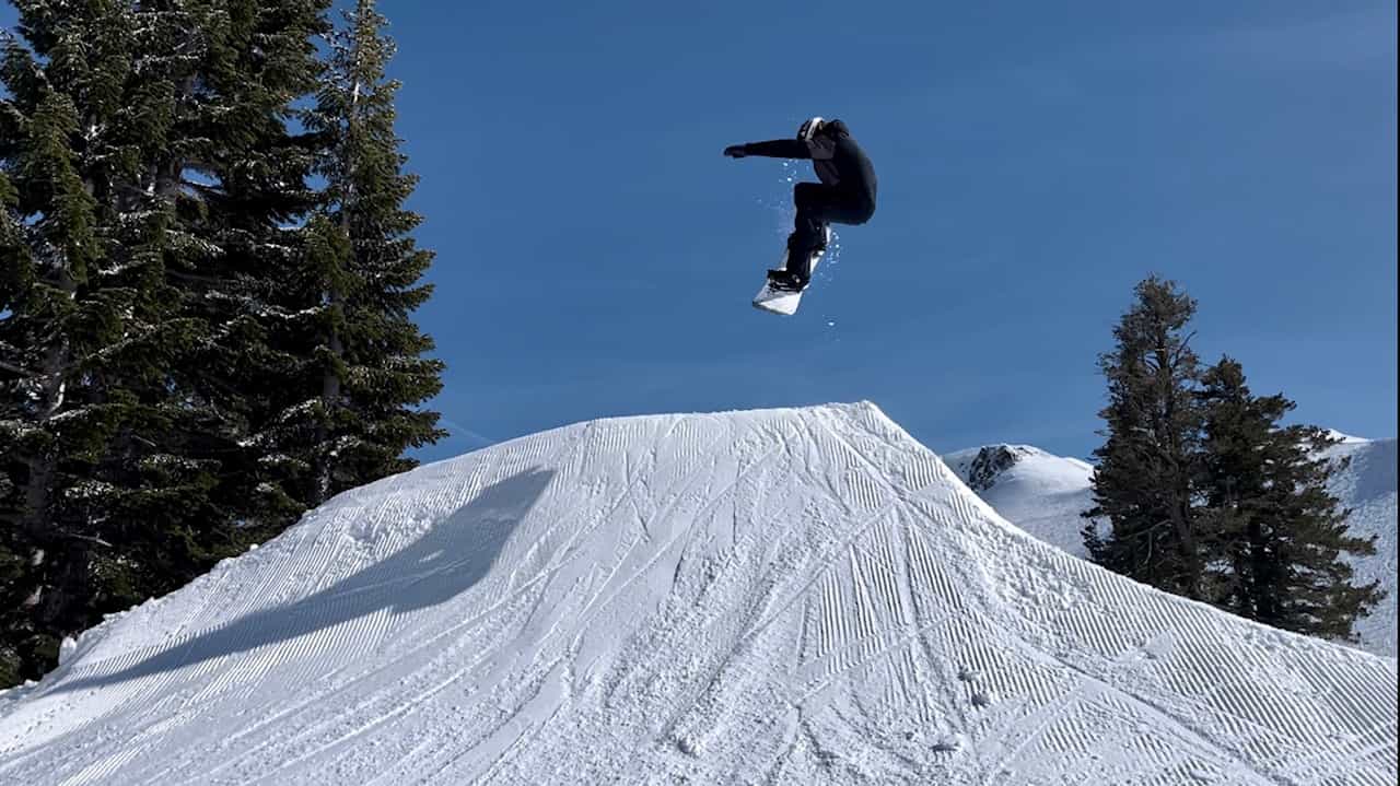 snowboarder going off jump