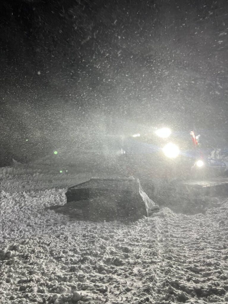 A snowcat in a storm at Palisades Tahoe.