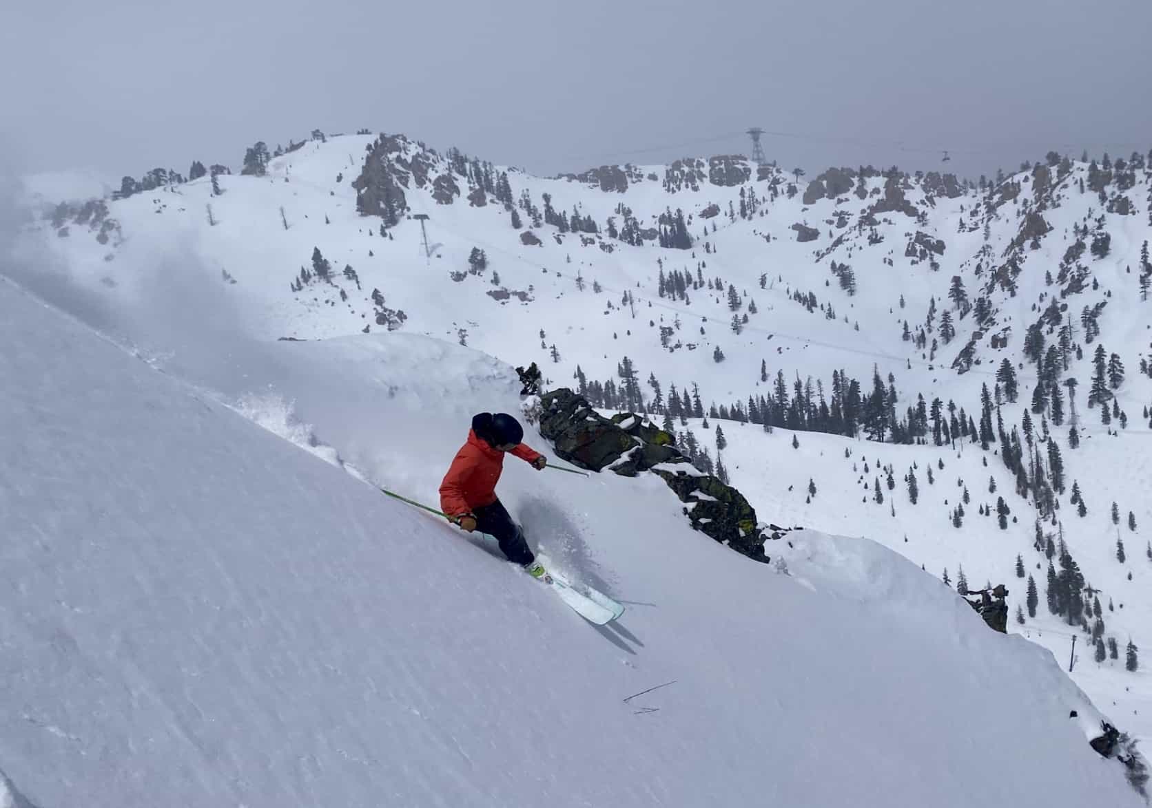 skier turning in deep powder in alternate chutes