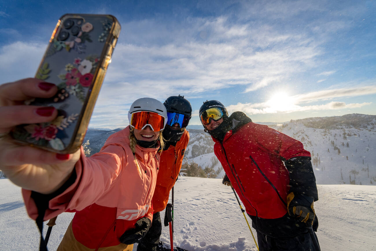 Taking a lifestyle selfie with a group of friends before skiing powder on the Palisades side of Palisades Tahoe