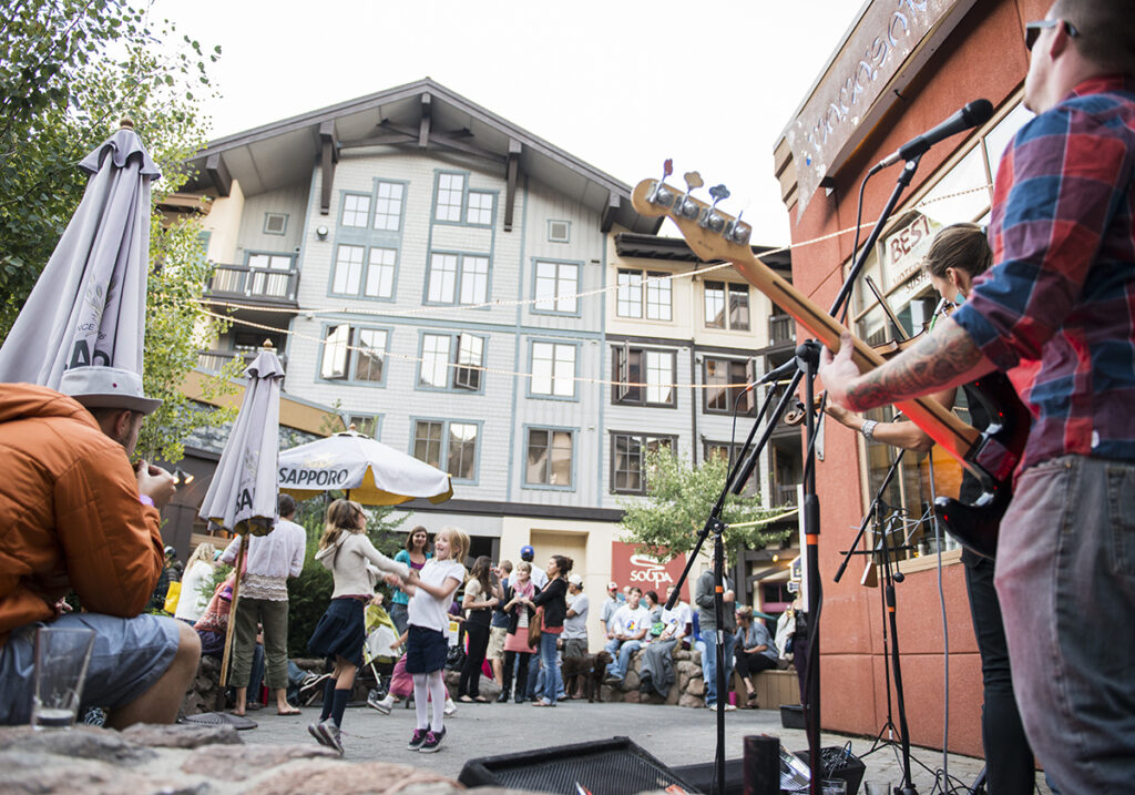 Kids dance to live music at Palisades Tahoe. 