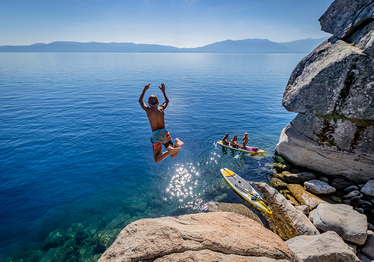 A boy jumps into Lake Tahoe.