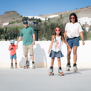 A family roller skates at Palisades Tahoe. 