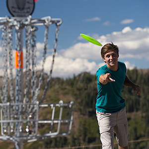A boy plays disc golf at Palisades Tahoe. 