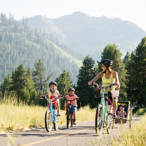 A family bikes through Lake Tahoe. 
