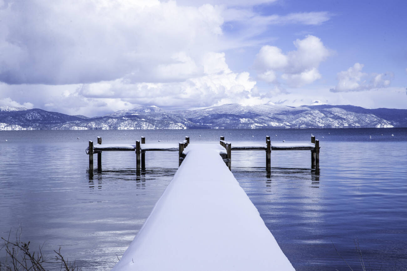 Image of beach in Tahoe City with snow-covered dock.