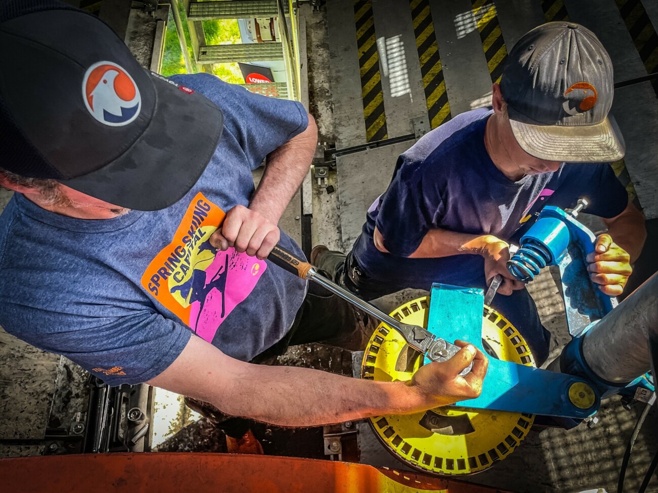 Two lift maintenance technicians working
