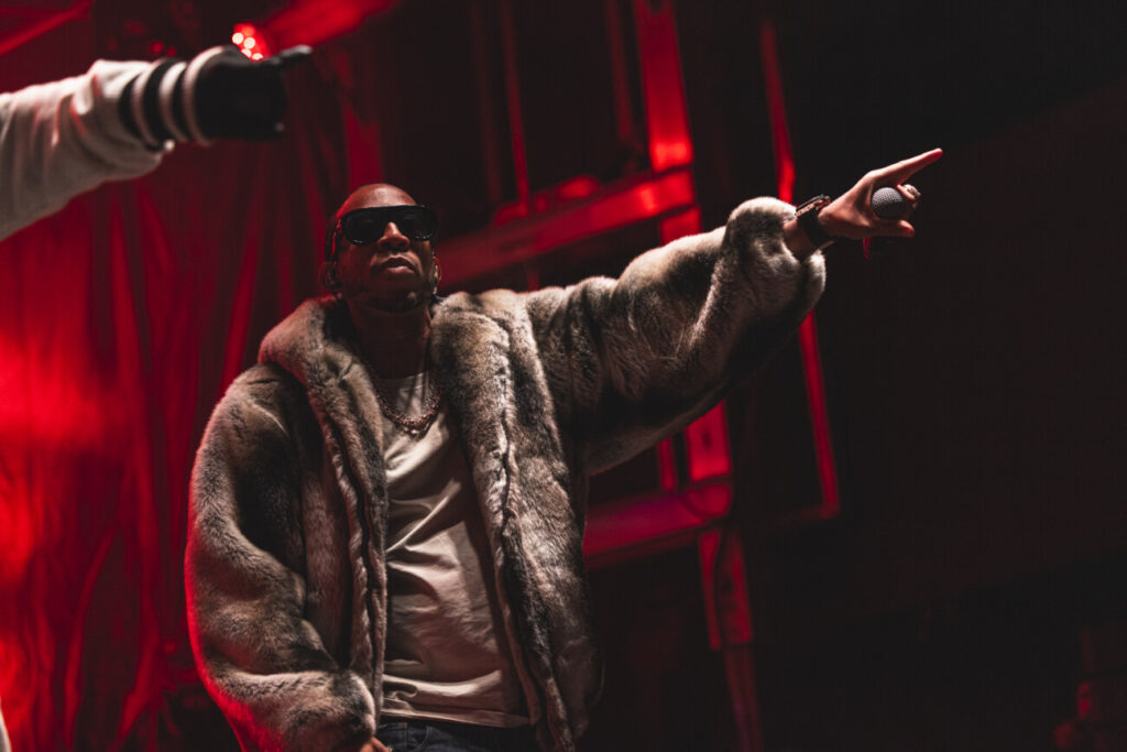 Ludacris performing on the KT-22 Deck stage in a fur coat.