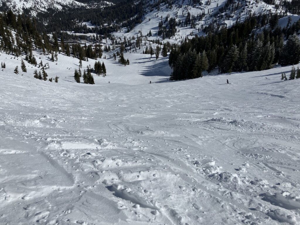 View down snowy ski slope