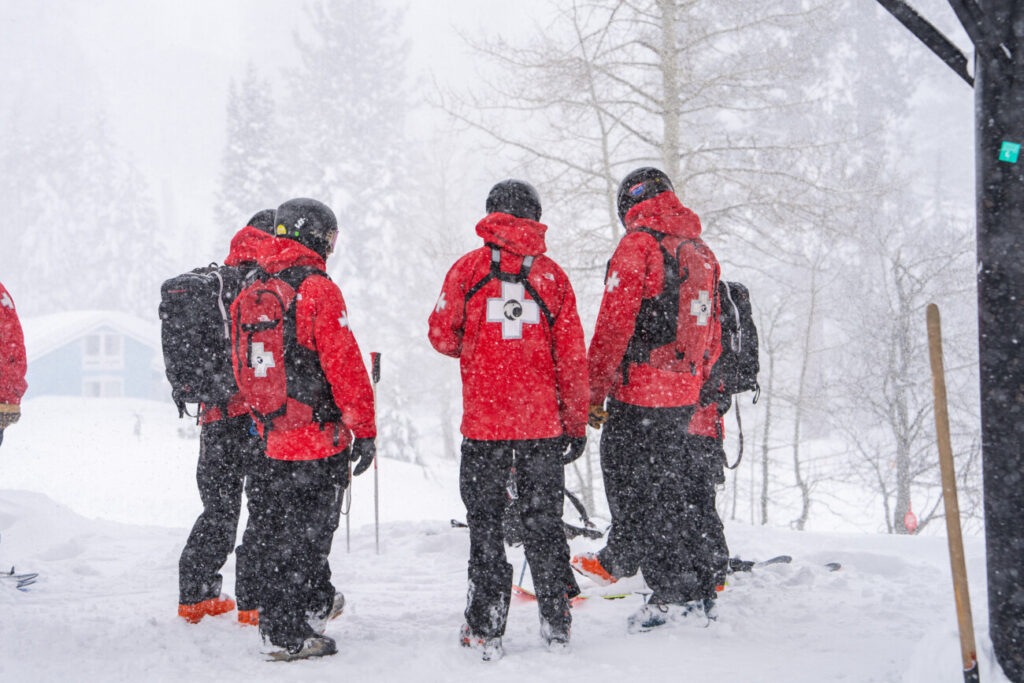 A group of ski patrollers in the snow.