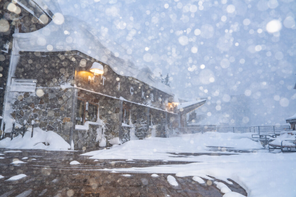 Snow falling by the ticket office in The Village at Palisades Tahoe.
