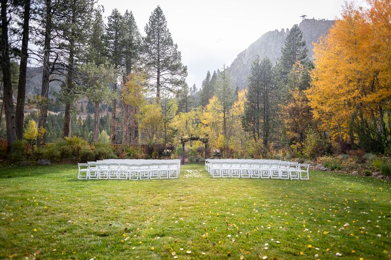 Picturesque fall colors border the seating area at a Palisades Tahoe wedding in Olympic Valley. 