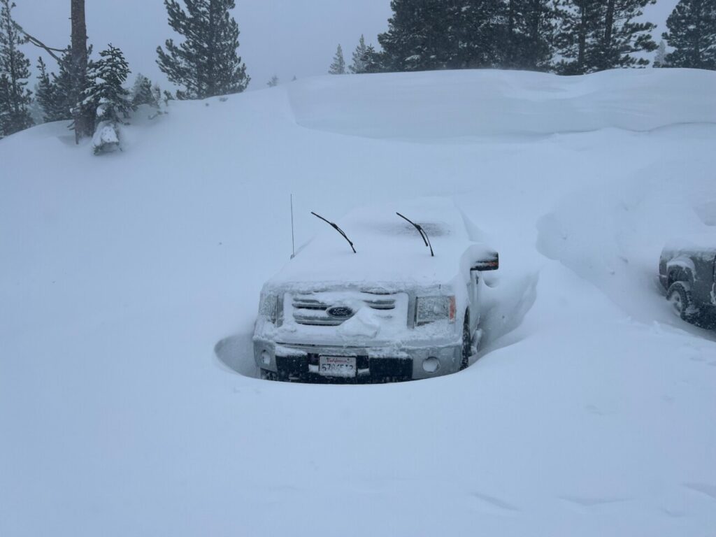 A truck buried in snow at Alpine Meadows.
