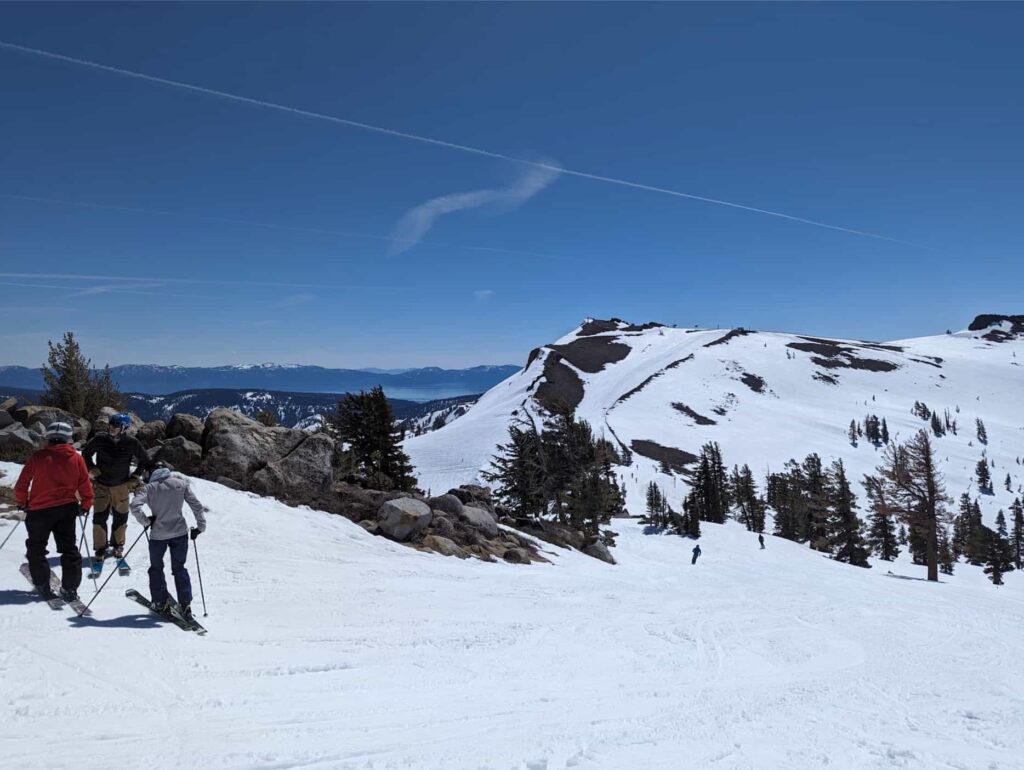 Lake Tahoe from Granite Chief Peak bluedird skies and snowy slopes