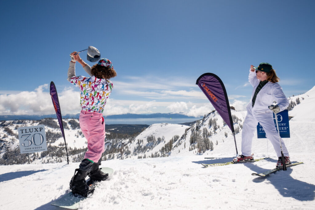 Two competitors for the annual Snow Golf tournament at the top of summit.