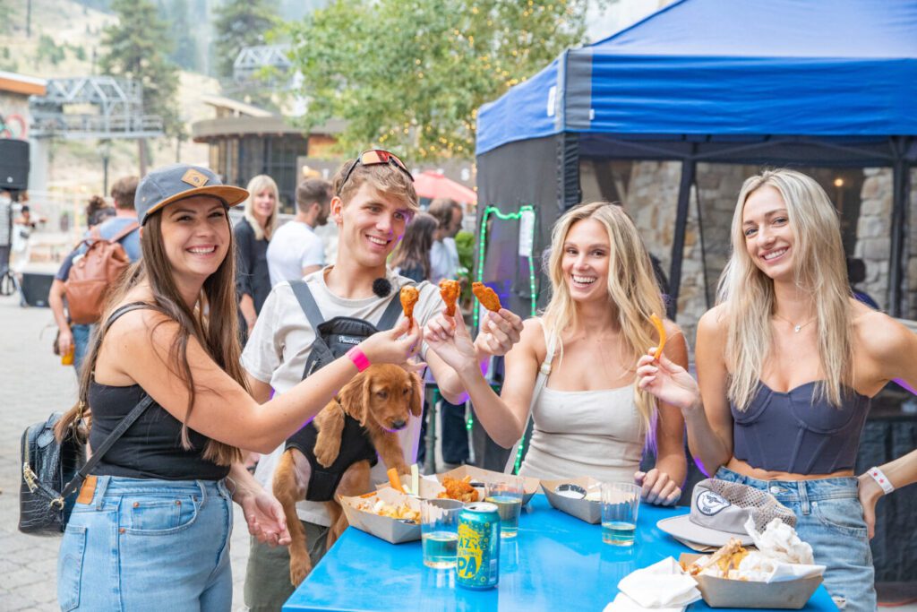 Group of friends sharing wings at Guitar Strings vs Chicken Wings