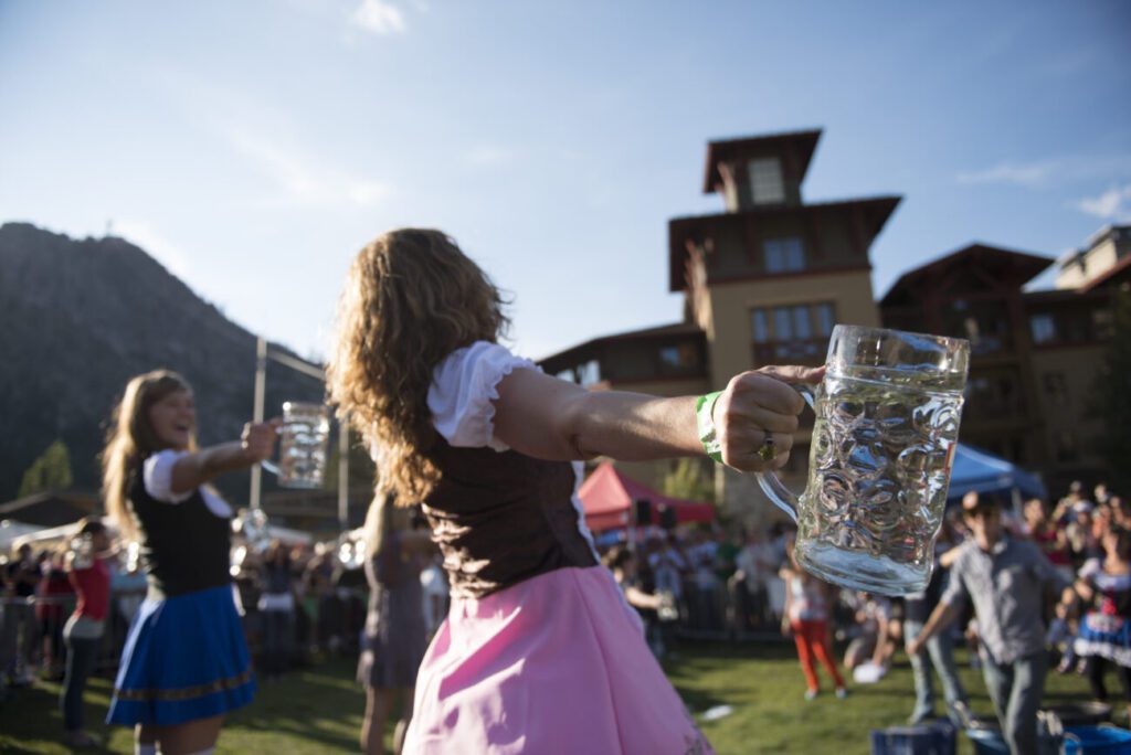Two girls facing off in steinholding at Oktoberfest