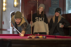 Group playing billiards in The Village at Palisades Tahoe