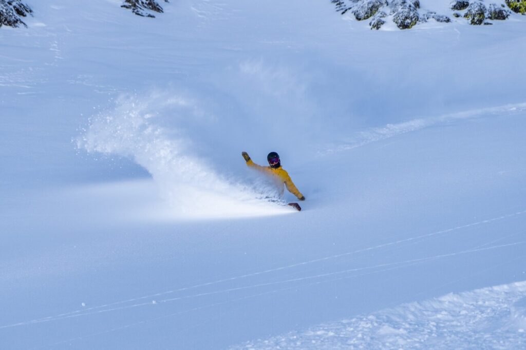 Tilden Wooley snowboards down a mountain