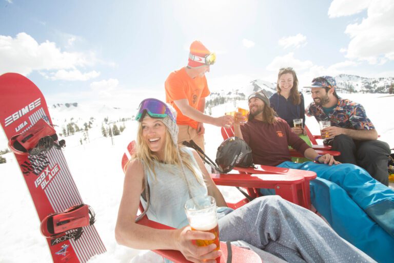 4 visitors take an apres ski break outside