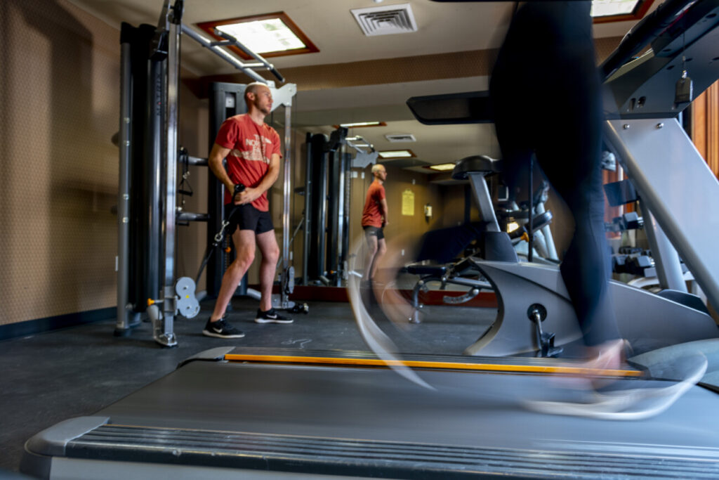 Guests work out in the fitness room