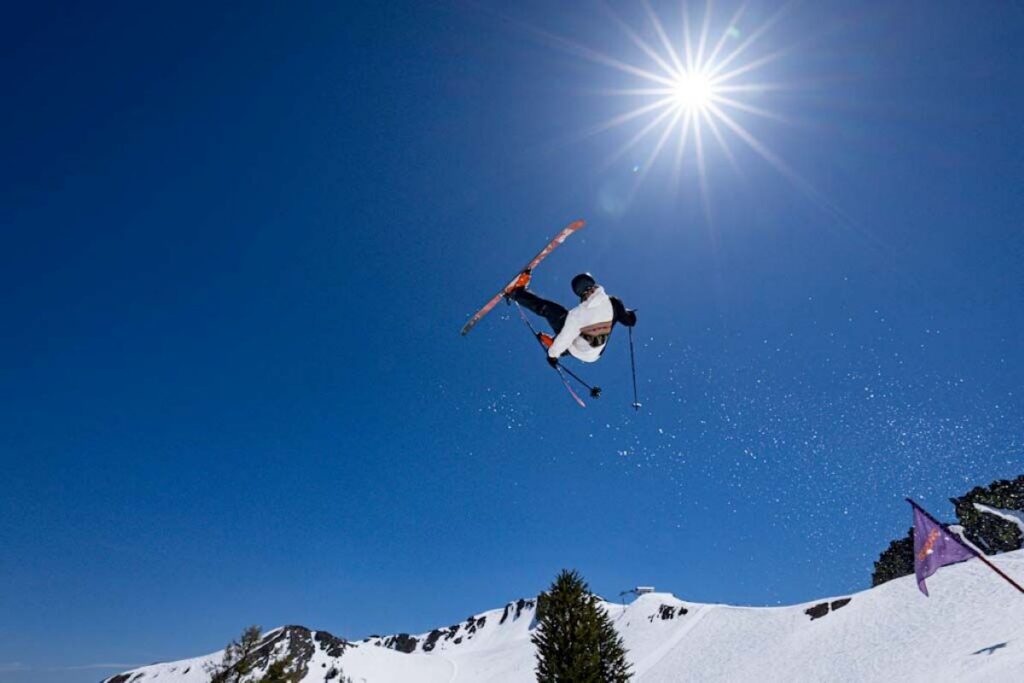 Skier catching air with sunshine