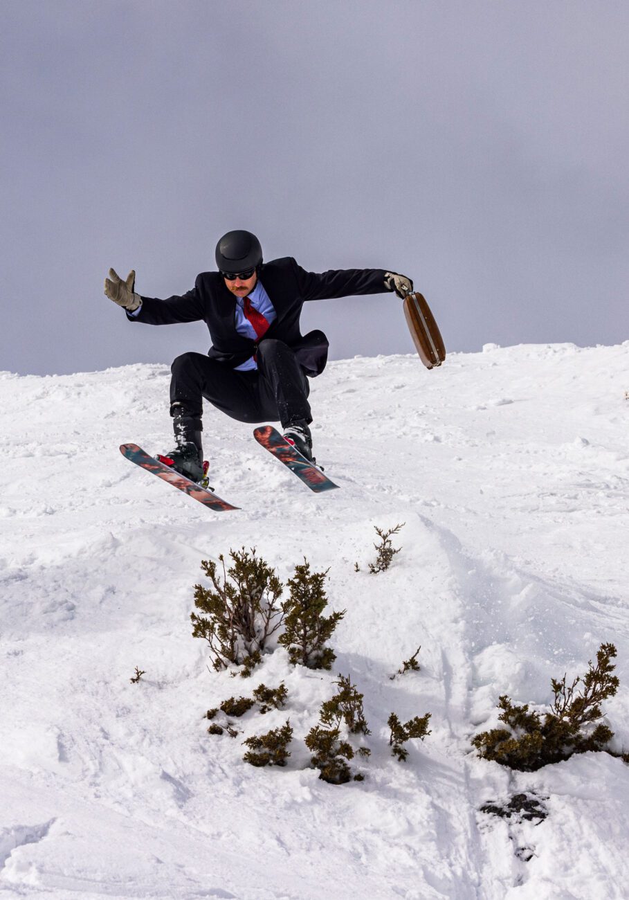 Skier sending a cliff in a full suite.