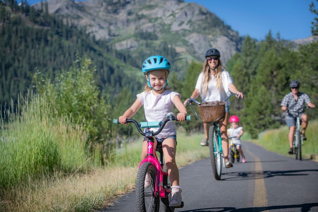 Family bike ride on bike path in Olympic Valley