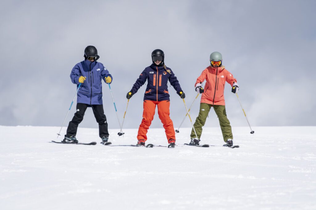 Ski instructor with two skiers