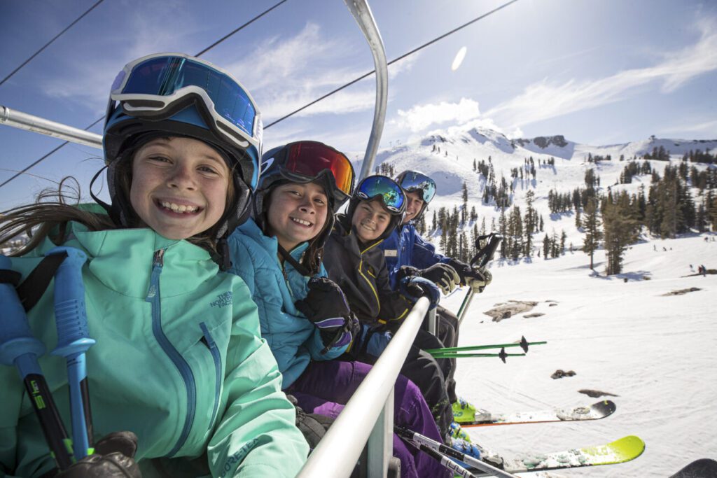 Kids riding the chairlift up the mountain